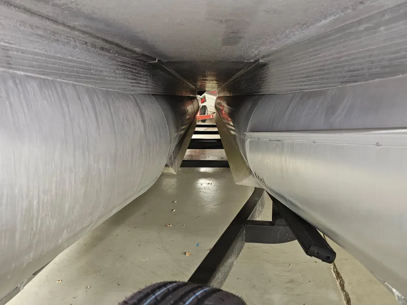 Slide: The Image of Underneath view of a 2018 Bennington SX25 pontoon boat on a trailer. - 17