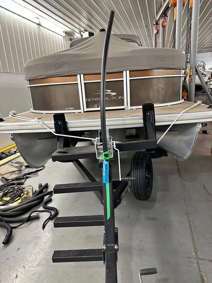Slide: The Image of 2018 Bennington SX25 pontoon boat on trailer in a garage setting. - 20