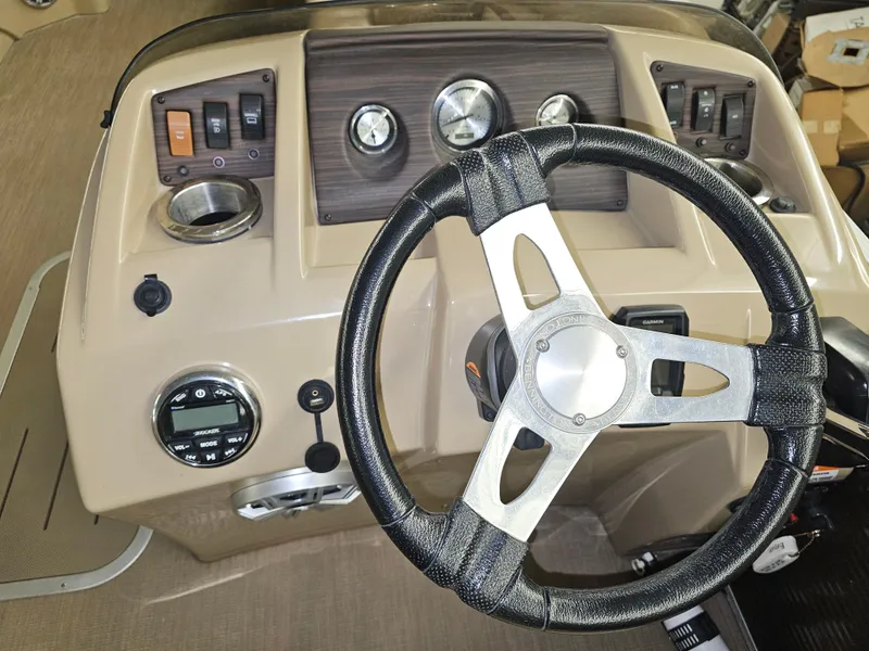 Slide: The Image of Steering wheel and dashboard of a 2018 Bennington SX25 boat. - 4