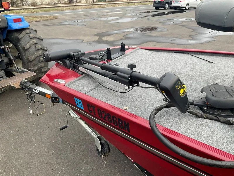 Slide: The Image of 2020 Tracker BASS TRACKER® Classic XL boat on trailer, red exterior, parked near tractor. - 4