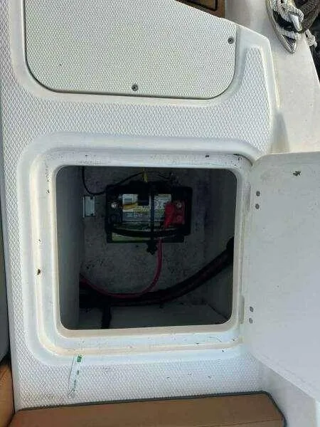 Slide: The Image of 2023 Chaparral 230 SSi boat battery compartment with open hatch. - 5