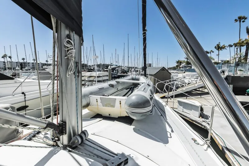 Slide: The Image of Sailboat deck view in marina, Hunter 456, 1997 model, with inflatable dinghy and clear blue sky. - 10