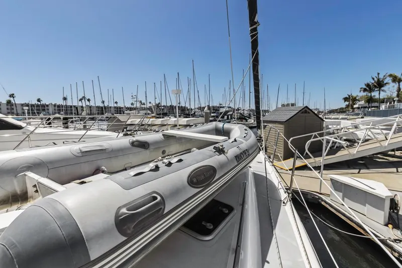 Slide: The Image of Sailboats docked at a marina under clear blue skies, featuring a 1997 Hunter 456. - 11