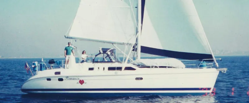 Slide: The Image of Sailing yacht Hunter 456, 1997 model, cruising on open water with two people on deck. - 12