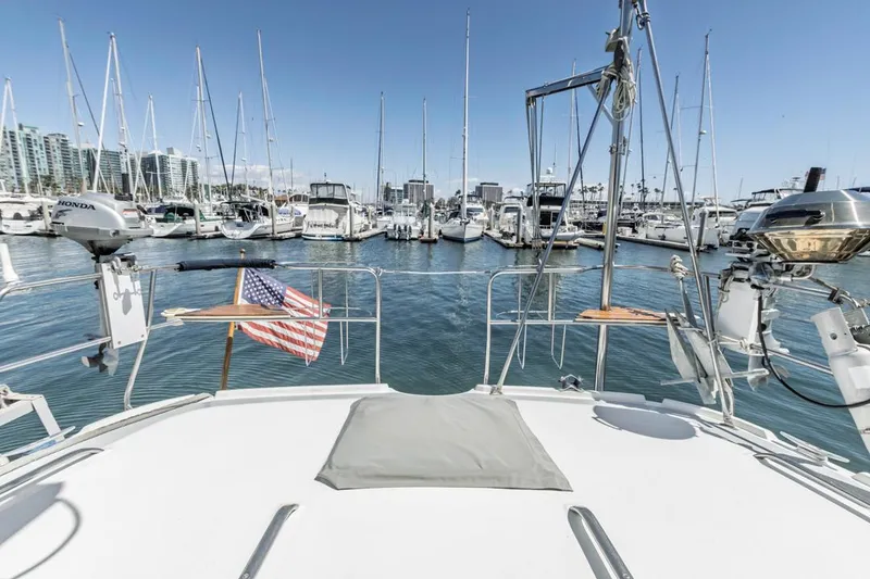 Slide: The Image of Sailboat docked in marina, Hunter 456 model, 1997, with American flag, clear sky. - 18