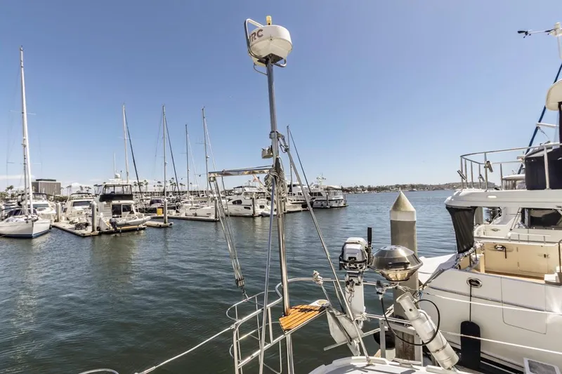 Slide: The Image of Marina with various boats, featuring a 1997 Hunter 456 sailboat in the foreground. - 19