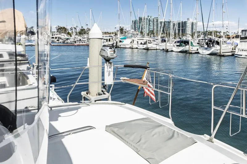 Slide: The Image of Hunter 456 yacht docked in marina, 1997 model, with cityscape and sailboats in background. - 20