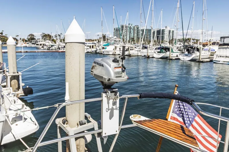 Slide: The Image of Sailboat docked in marina with American flag, featuring a 1997 Hunter 456 model. - 21