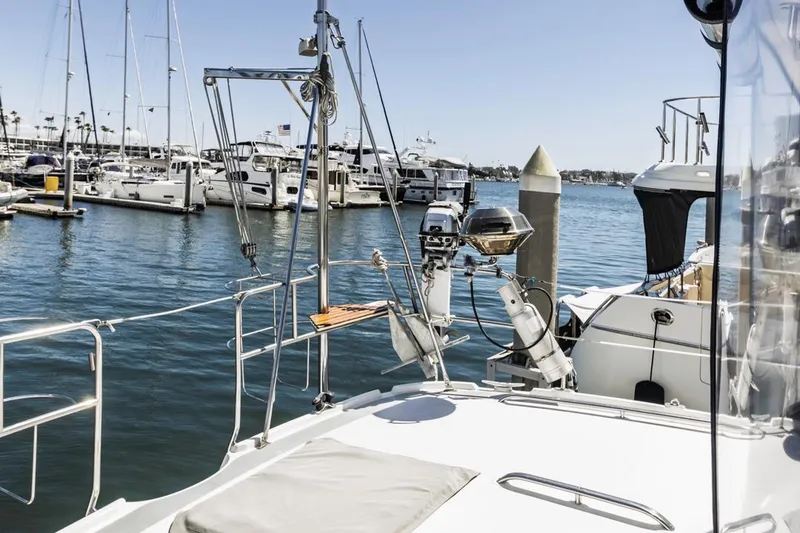 Slide: The Image of Sailboats docked at a marina, featuring a 1997 Hunter 456 yacht in the foreground. - 22