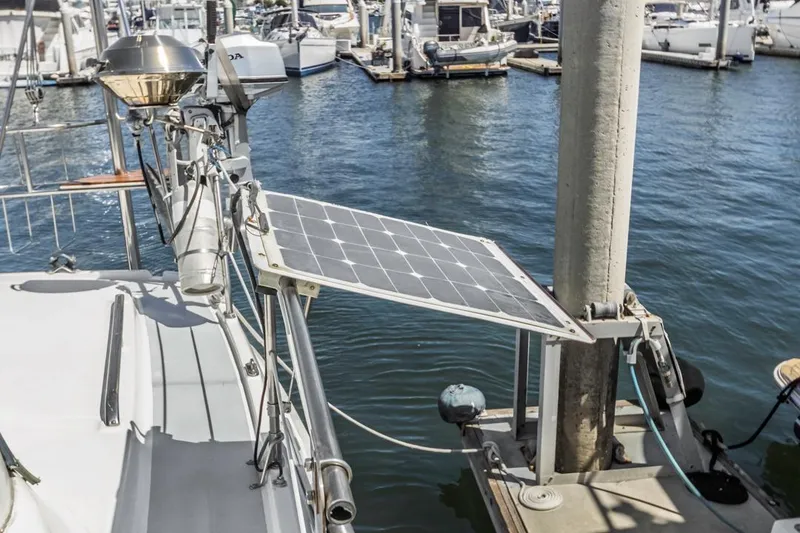 Slide: The Image of Sailboat with solar panel docked at marina, Hunter 456, 1997 model. - 24