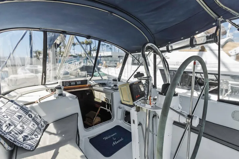 Slide: The Image of Cockpit of 1997 Hunter 456 sailboat with steering wheel and navigation equipment. - 27