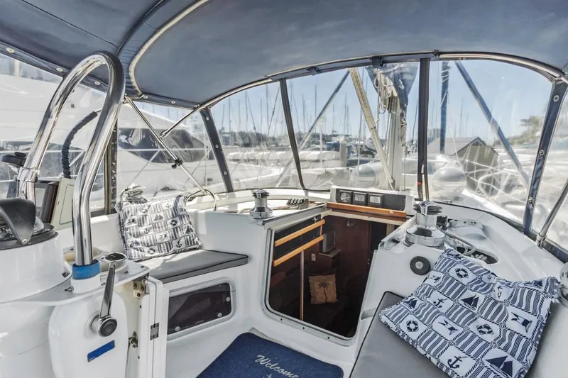 Slide: The Image of Interior of a 1997 Hunter 456 sailboat with nautical-themed cushions. - 28