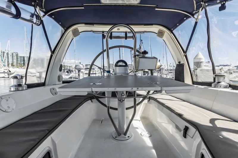 Slide: The Image of Interior view of a 1997 Hunter 456 sailboat cockpit with marina background. - 3