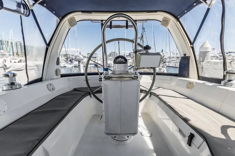 Slide: The Image of Interior view of a 1997 Hunter 456 sailboat cockpit with steering wheel and navigation equipment. - 31