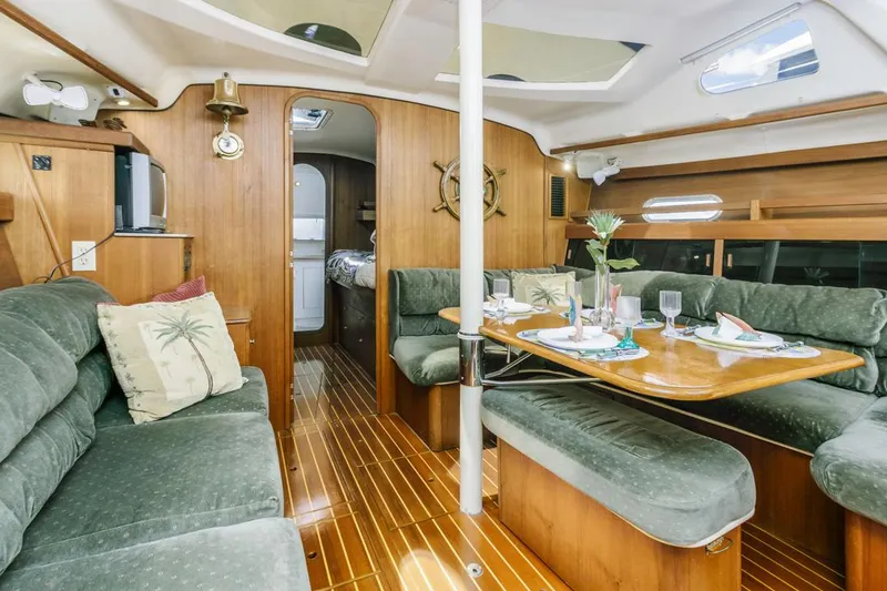 Slide: The Image of Luxurious 1997 Hunter 456 yacht interior with elegant wood finish and plush seating. - 32