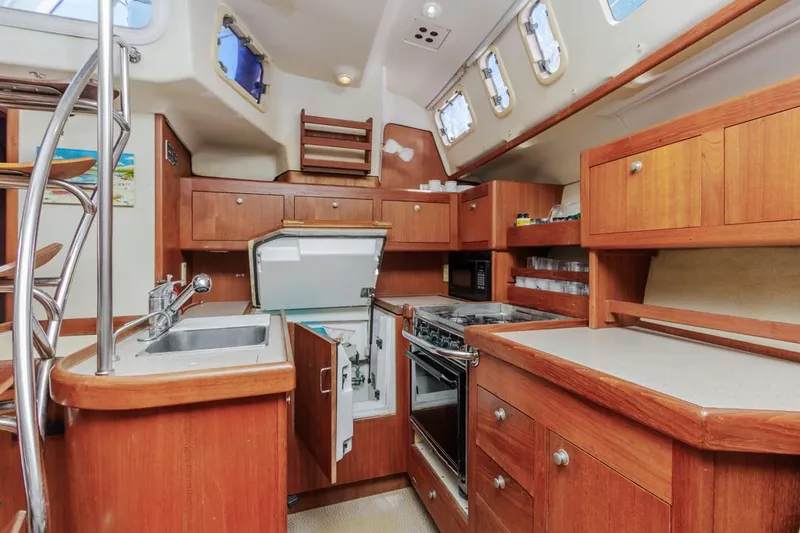 Slide: The Image of Interior of 1997 Hunter 456 sailboat kitchen with wooden cabinetry and modern appliances. - 37
