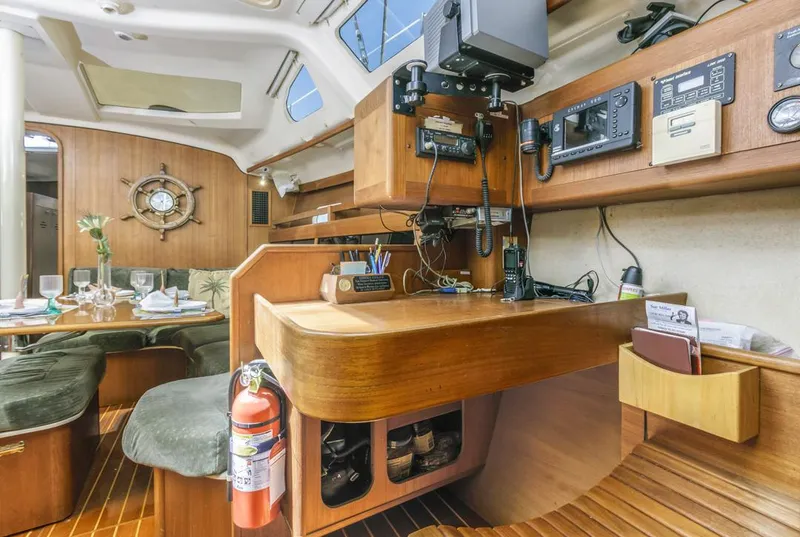 Slide: The Image of Interior of a 1997 Hunter 456 sailboat with navigation equipment and dining area. - 38