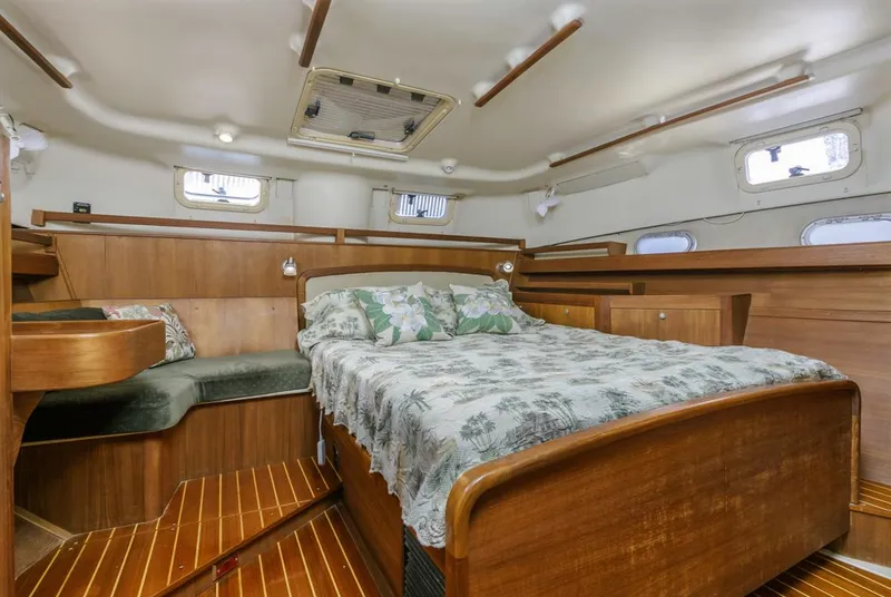 Slide: The Image of Luxurious 1997 Hunter 456 yacht cabin with wooden interior and comfortable bed. - 4