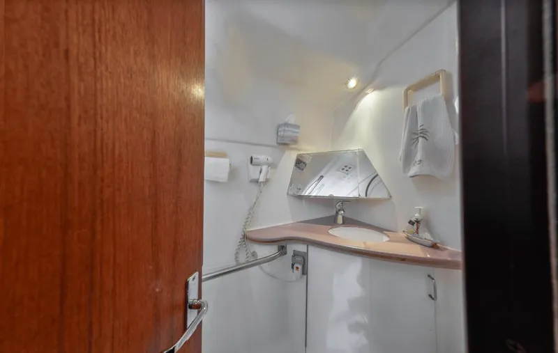 Slide: The Image of Compact bathroom in 1997 Hunter 456 yacht with sink, mirror, and towel rack. - 40