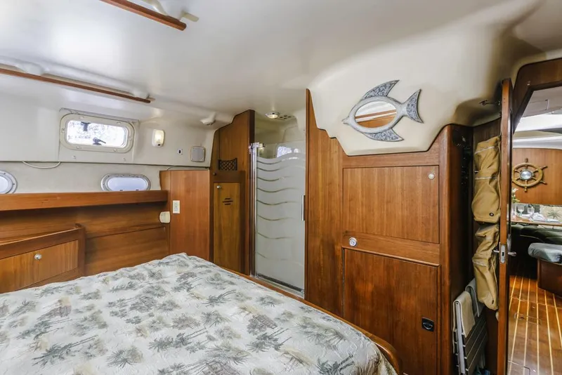 Slide: The Image of Cozy cabin interior of 1997 Hunter 456 yacht with wooden decor and nautical accents. - 46