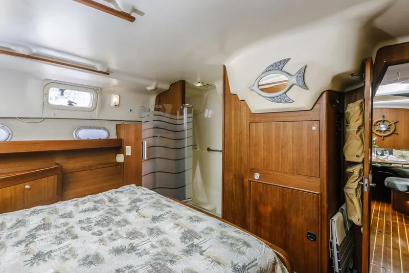 Slide: The Image of Cozy cabin interior of 1997 Hunter 456 sailboat with wooden furnishings and nautical decor. - 47