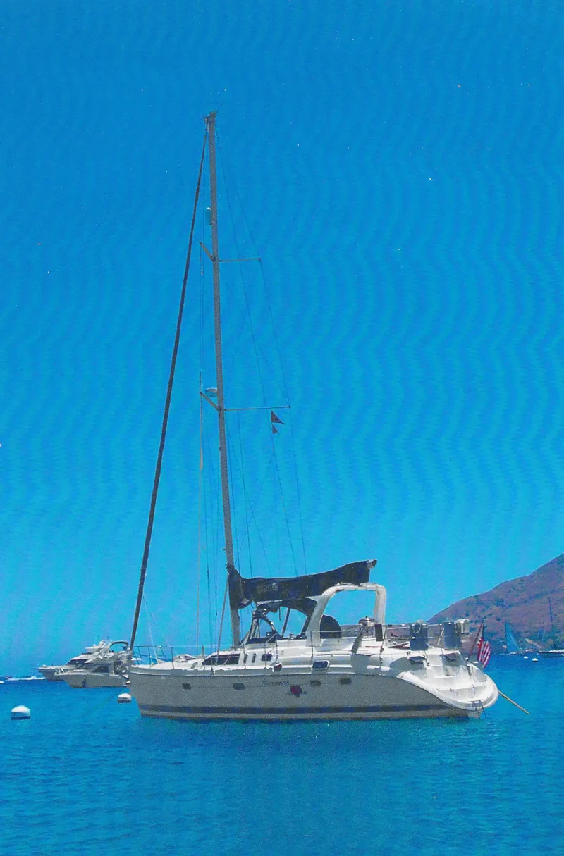 Slide: The Image of Sailboat Hunter 456 (1997) anchored in clear blue waters under a bright sky. - 5
