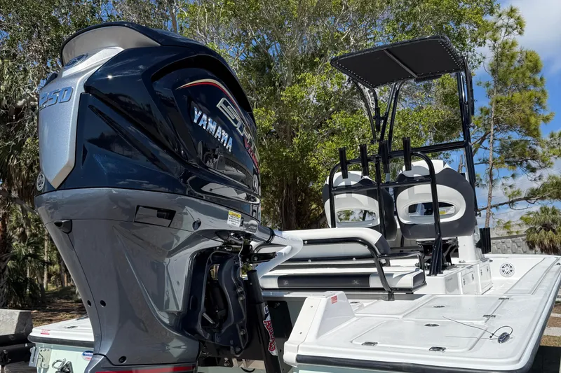 Slide: The Image of 2025 Tidewater 25 TPC Raptor boat with Yamaha engine, parked outdoors. - 6