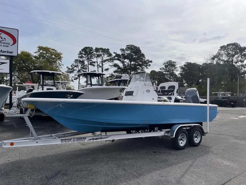 Slide: The Image of 2025 Tidewater 2110 Bay Max boat on trailer, parked outdoors at a dealership. - 1