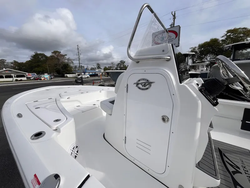 Slide: The Image of 2025 Tidewater 2110 Bay Max boat, white console, outdoor setting, cloudy sky. - 12