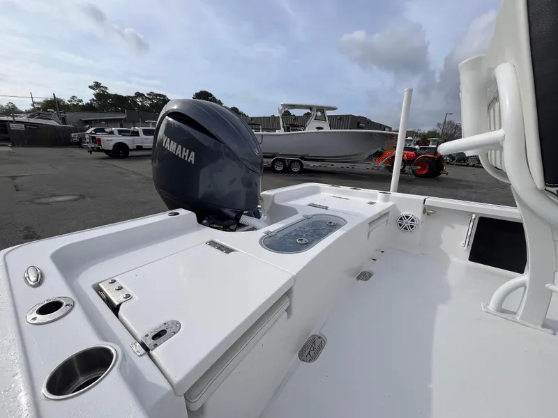 Slide: The Image of 2025 Tidewater 2110 Bay Max boat with Yamaha engine, docked outdoors. - 4