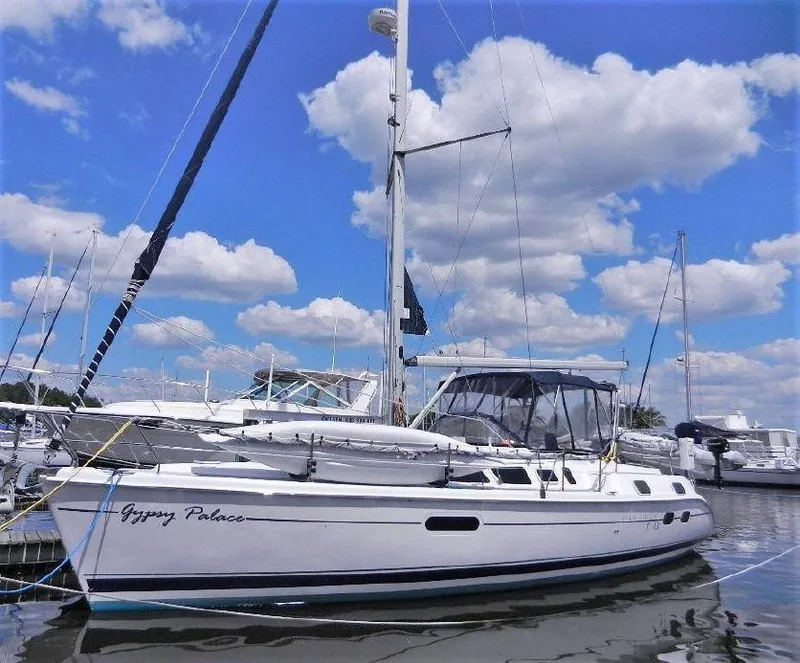 Slide: The Image of 2003 Hunter Passage 420 sailboat docked under a blue sky with clouds. - 0