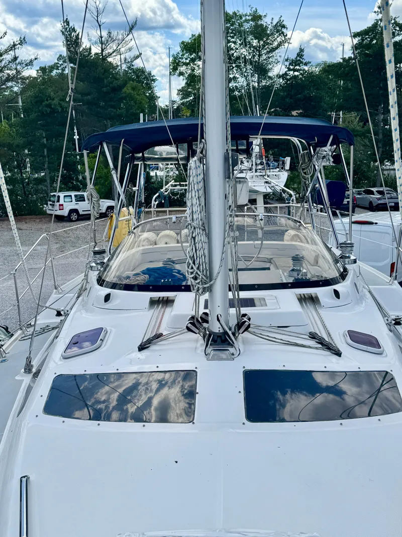 Slide: The Image of 2003 Hunter Passage 420 sailboat docked, featuring sleek design and spacious deck. - 13