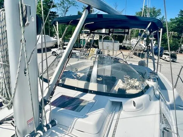 Slide: The Image of 2003 Hunter Passage 420 sailboat with cockpit view, featuring a blue canopy and steering wheel. - 16