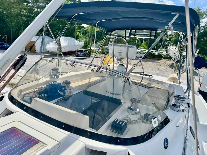 Slide: The Image of 2003 Hunter Passage 420 sailboat cockpit with blue canopy and steering wheel. - 18