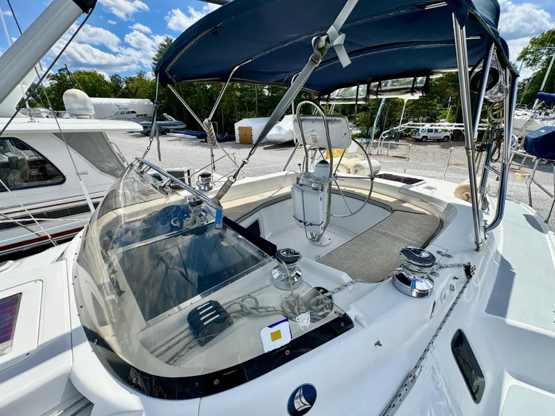 Slide: The Image of 2003 Hunter Passage 420 sailboat cockpit with blue canopy and steering wheel. - 19