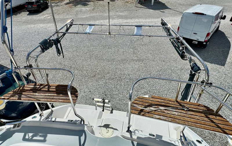 Slide: The Image of 2003 Hunter Passage 420 sailboat deck with wooden seating and metal railings. - 21