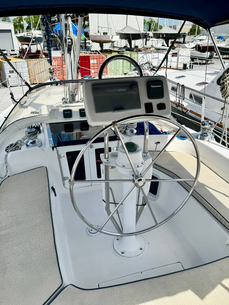 Slide: The Image of 2003 Hunter Passage 420 yacht cockpit with steering wheel and navigation system. - 23