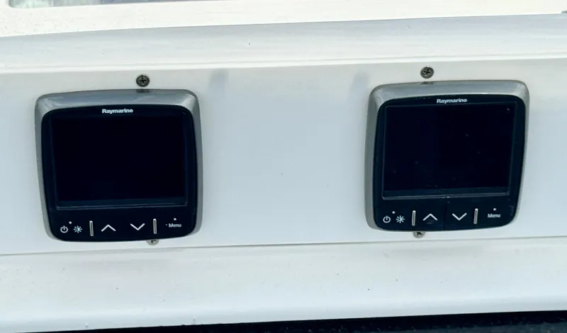 Slide: The Image of Dual Raymarine displays on a 2003 Hunter Passage 420 yacht dashboard. - 27
