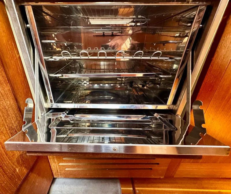 Slide: The Image of Open stainless steel oven inside a 2003 Hunter Passage 420 yacht kitchen. - 33