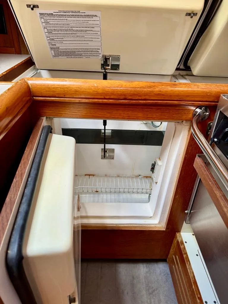 Slide: The Image of 2003 Hunter Passage 420 yacht interior fridge with wooden trim. - 34