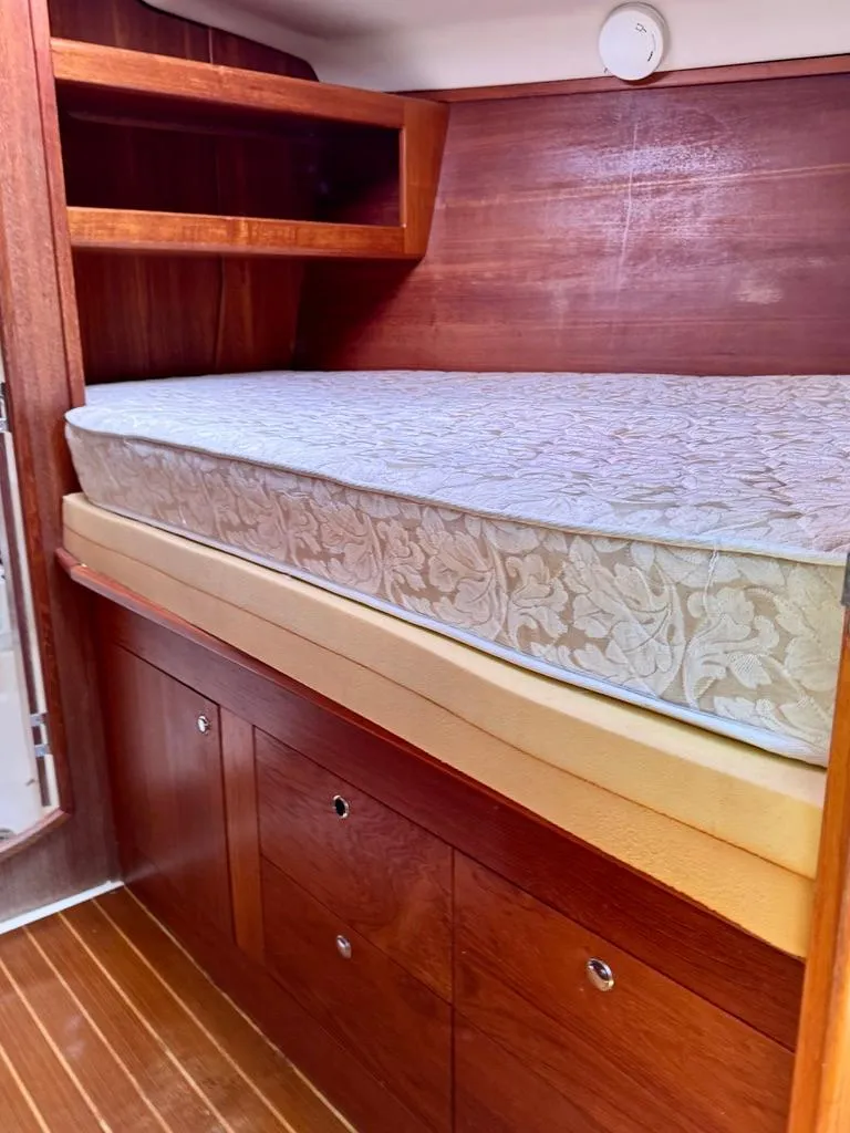 Slide: The Image of Interior cabin of 2003 Hunter Passage 420 sailboat with wooden storage and mattress. - 39