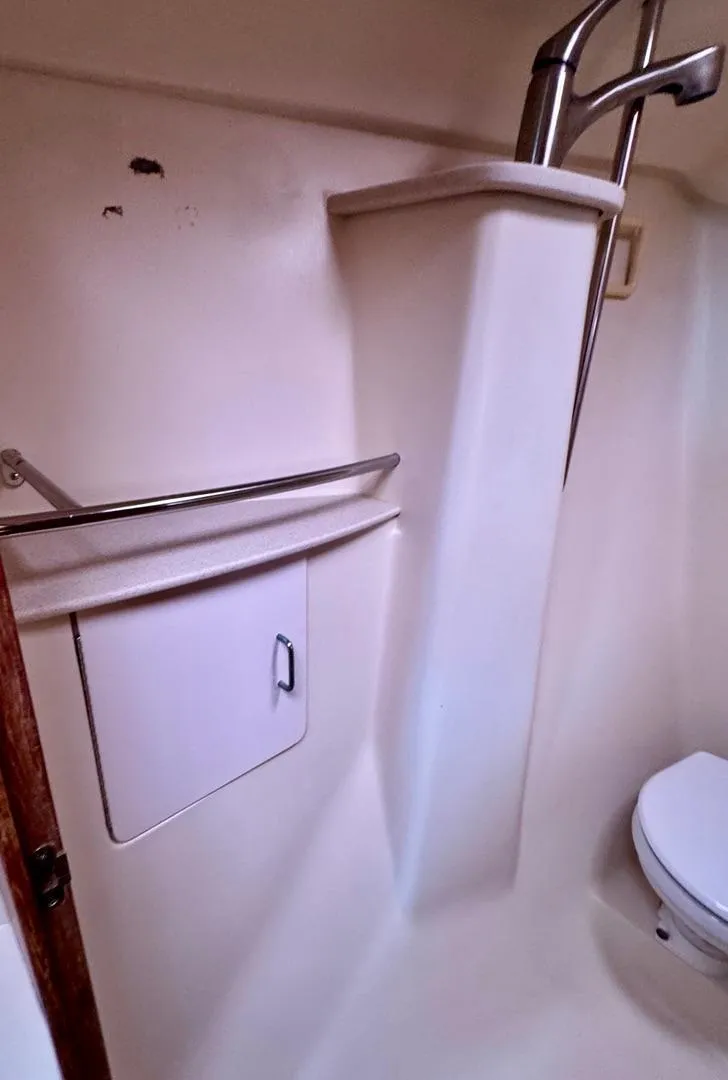 Slide: The Image of 2003 Hunter Passage 420 bathroom with white fixtures and compact design. - 41