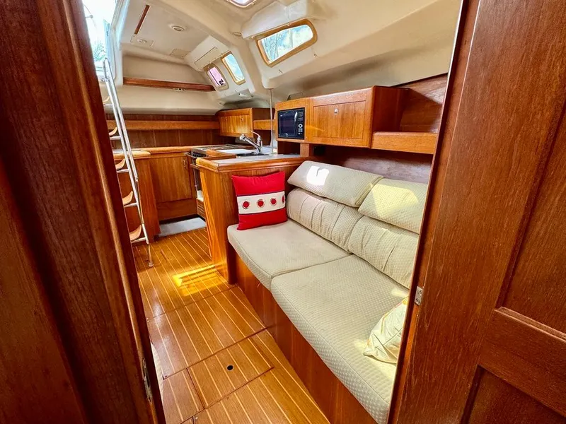 Slide: The Image of Interior of 2003 Hunter Passage 420 yacht with cozy seating and wooden cabinetry. - 44