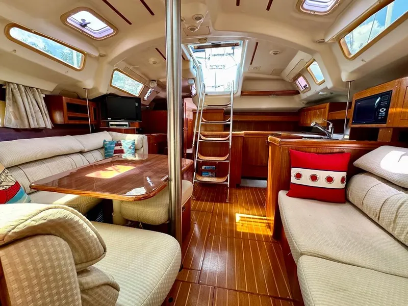 Slide: The Image of Interior of 2003 Hunter Passage 420 sailboat with cozy seating and wooden finishes. - 45