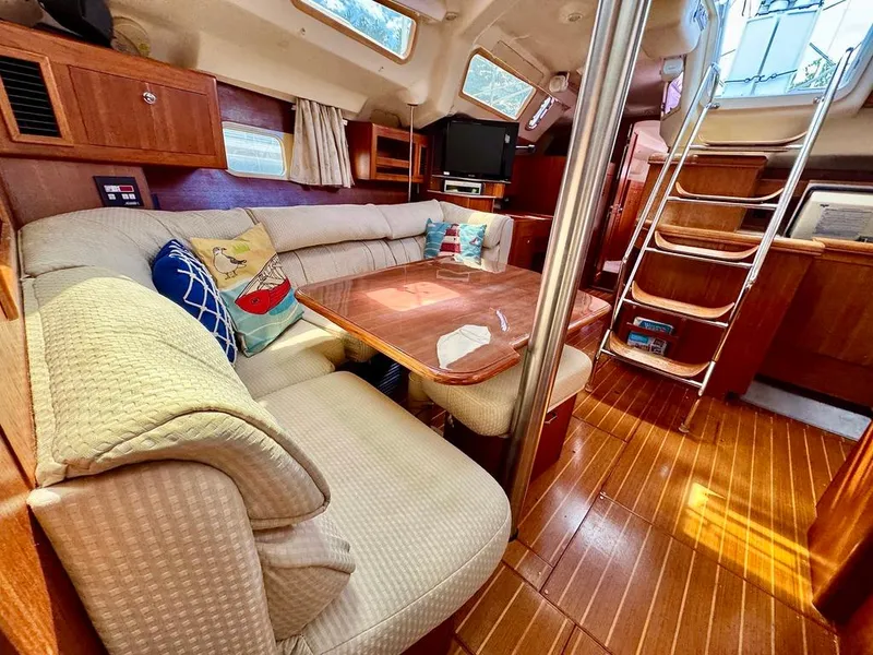 Slide: The Image of Interior of 2003 Hunter Passage 420 sailboat with cozy seating and wooden finishes. - 46