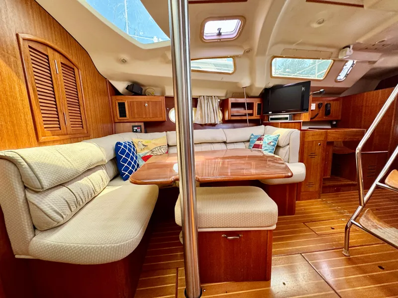 Slide: The Image of Interior of 2003 Hunter Passage 420 yacht with cozy seating and wooden finishes. - 47