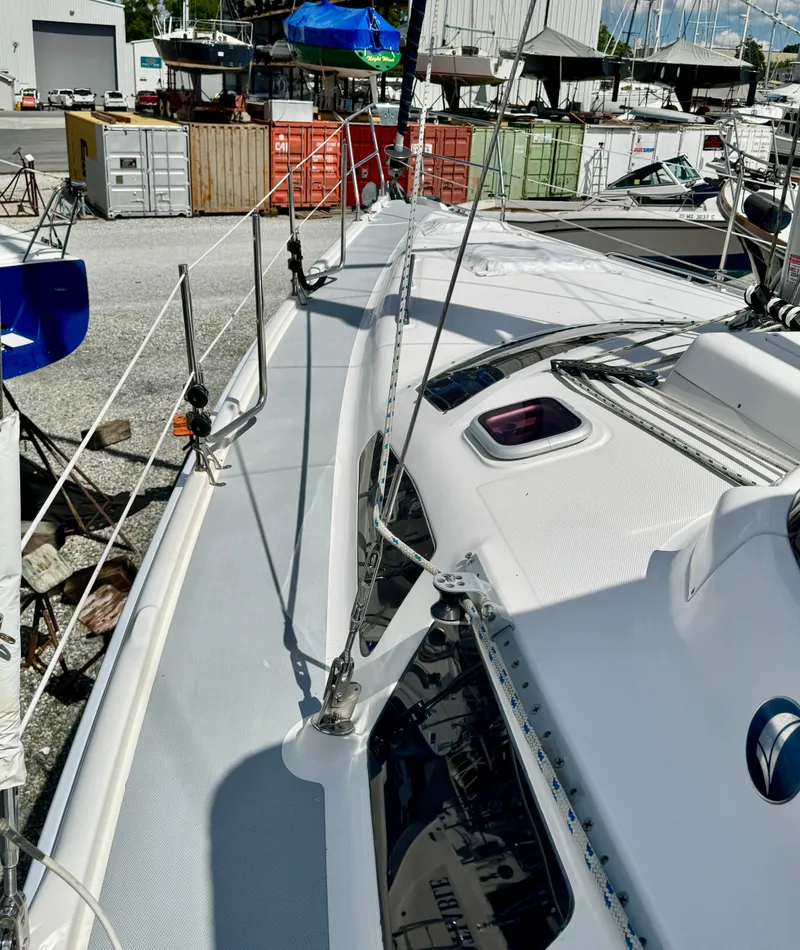 Slide: The Image of 2003 Hunter Passage 420 sailboat deck view in a marina setting. - 6