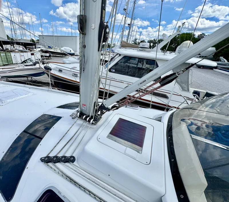 Slide: The Image of 2003 Hunter Passage 420 sailboat deck with rigging, docked among other boats. - 7