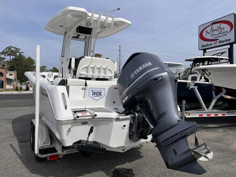 Slide: The Image of 2025 Tidewater 232 LXF boat with Yamaha engine, displayed at a marine dealership. - 3