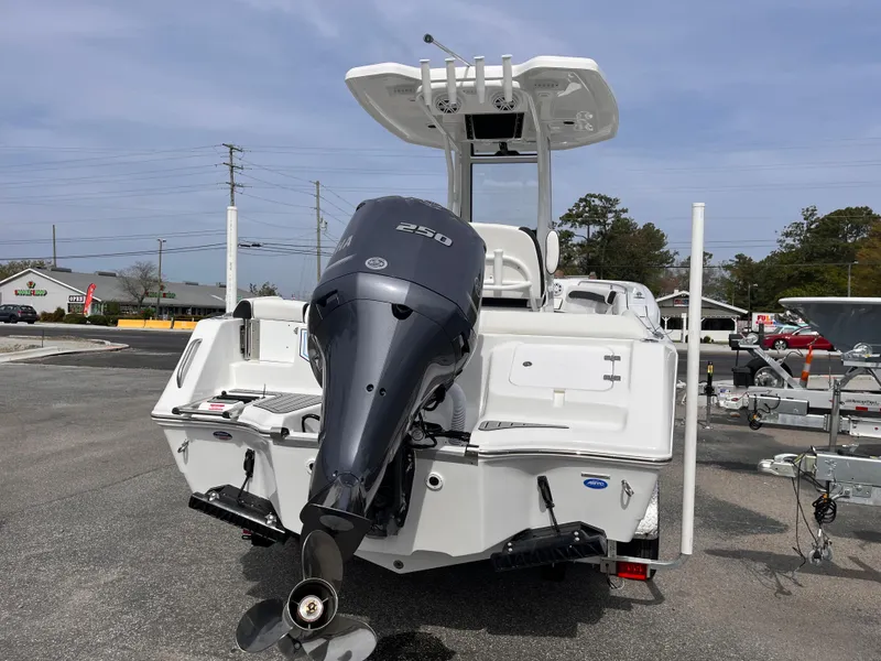 Slide: The Image of 2025 Tidewater 232 LXF boat with powerful outboard motor, parked on a trailer. - 4